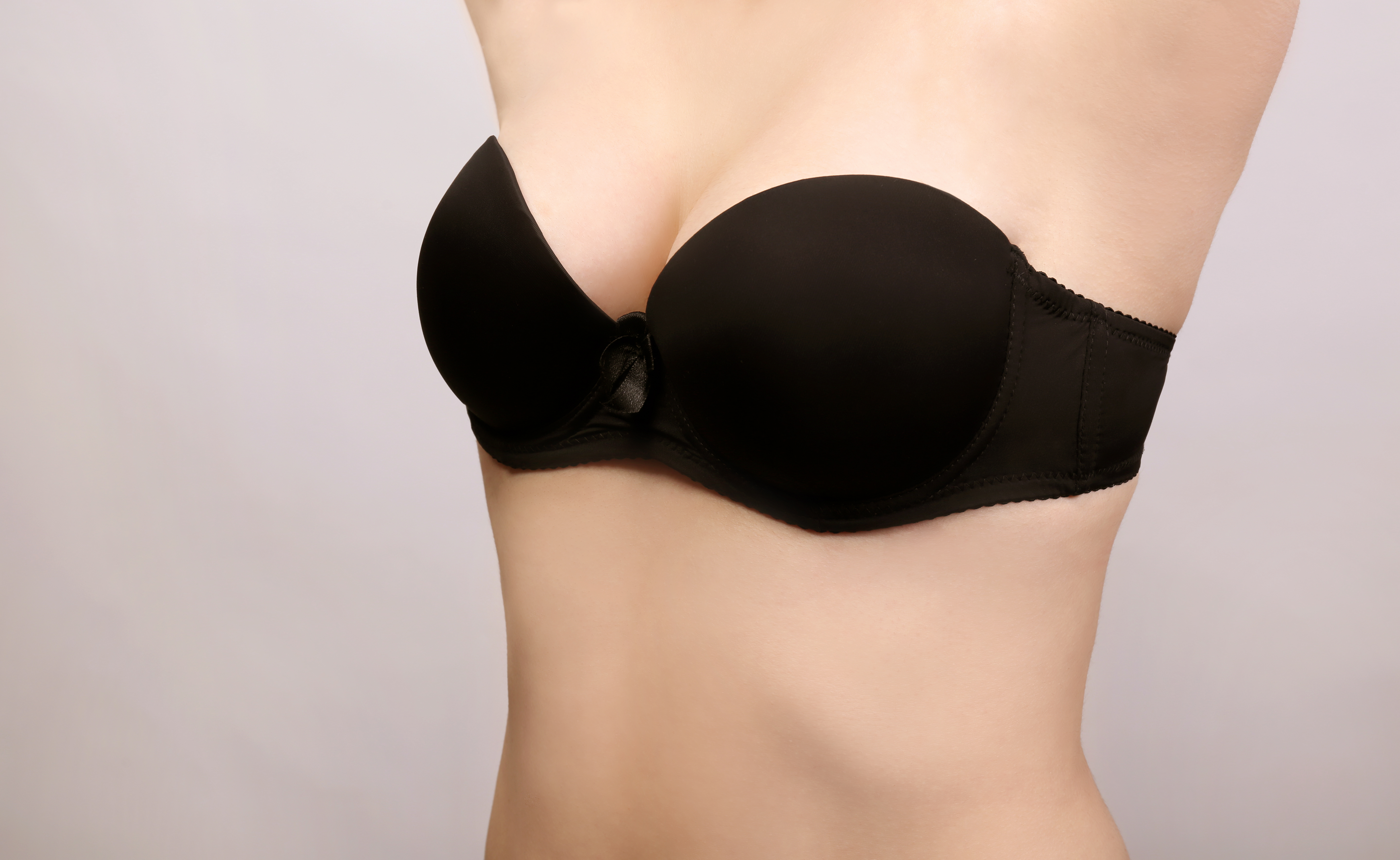 young-woman-black-bra-light-background-closeup-view.jpg